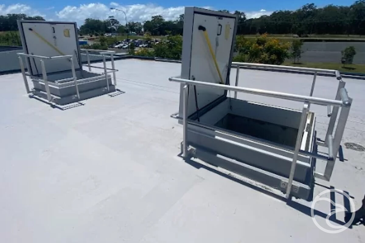 Water Tank Maintenance? - Metal doors on roof with ladder.