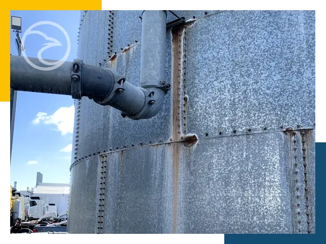 Maintenance crew servicing a large steel water tank