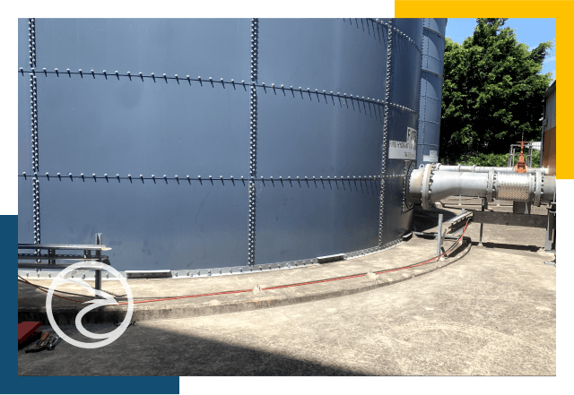 Metal fire tank inspections with blue and yellow frame.