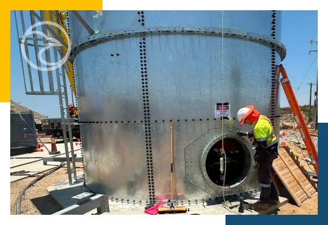 Technician performing confined space inspection with harness and ventilation system